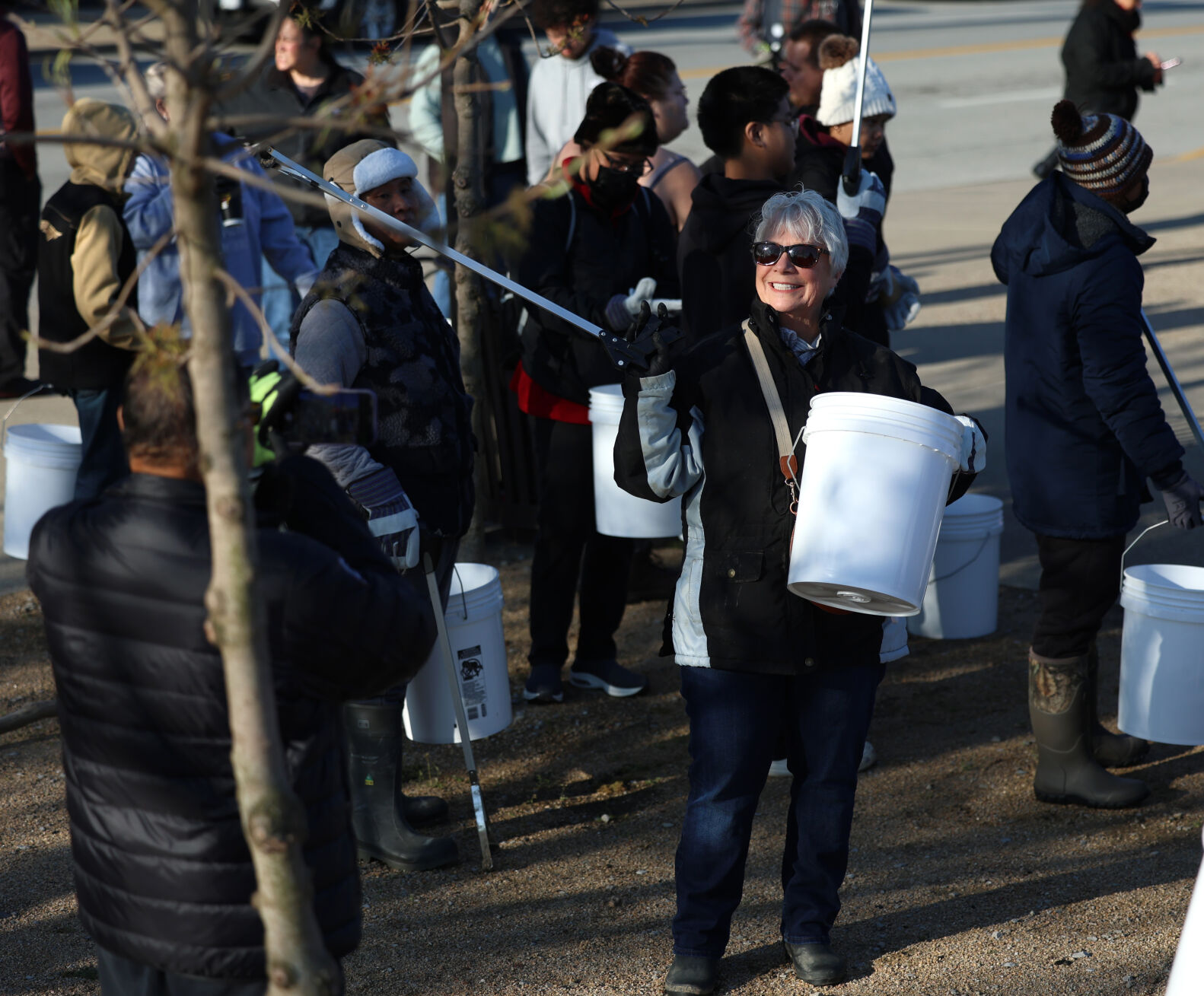 Woman takes photo with bucket